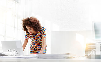  Woman reading from monitor in an office