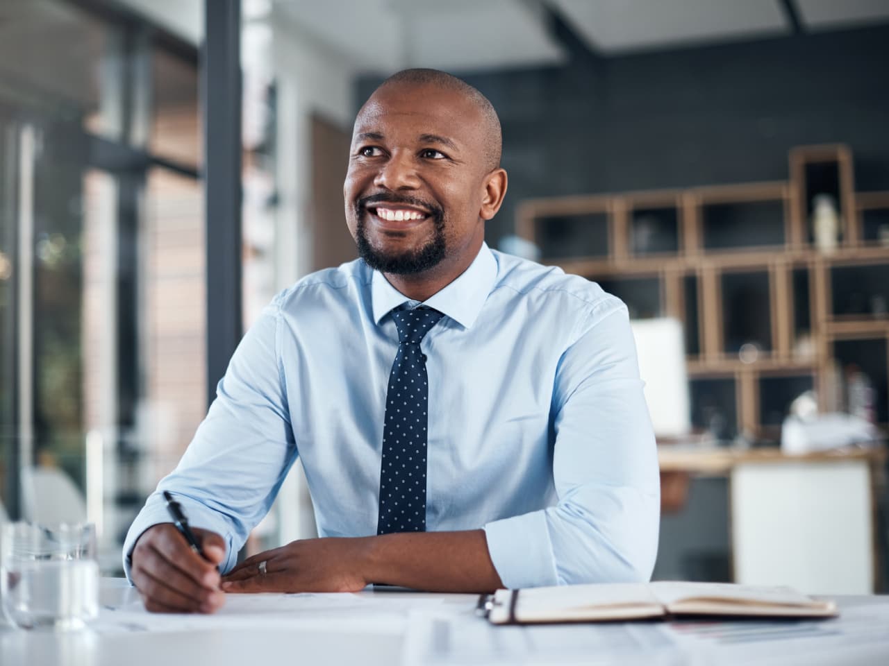 A smiling male employee in a performance interview