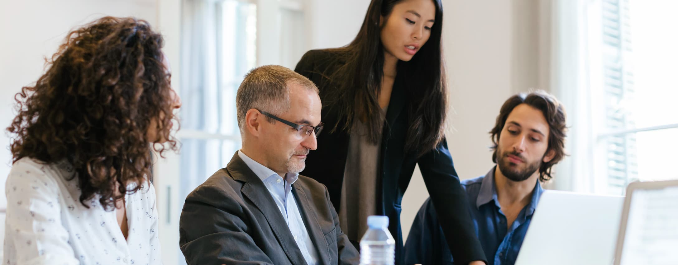 Group of people reviewing information on a computer