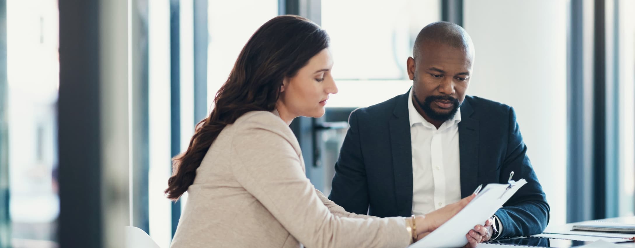 A man and a woman reviewing paperwork