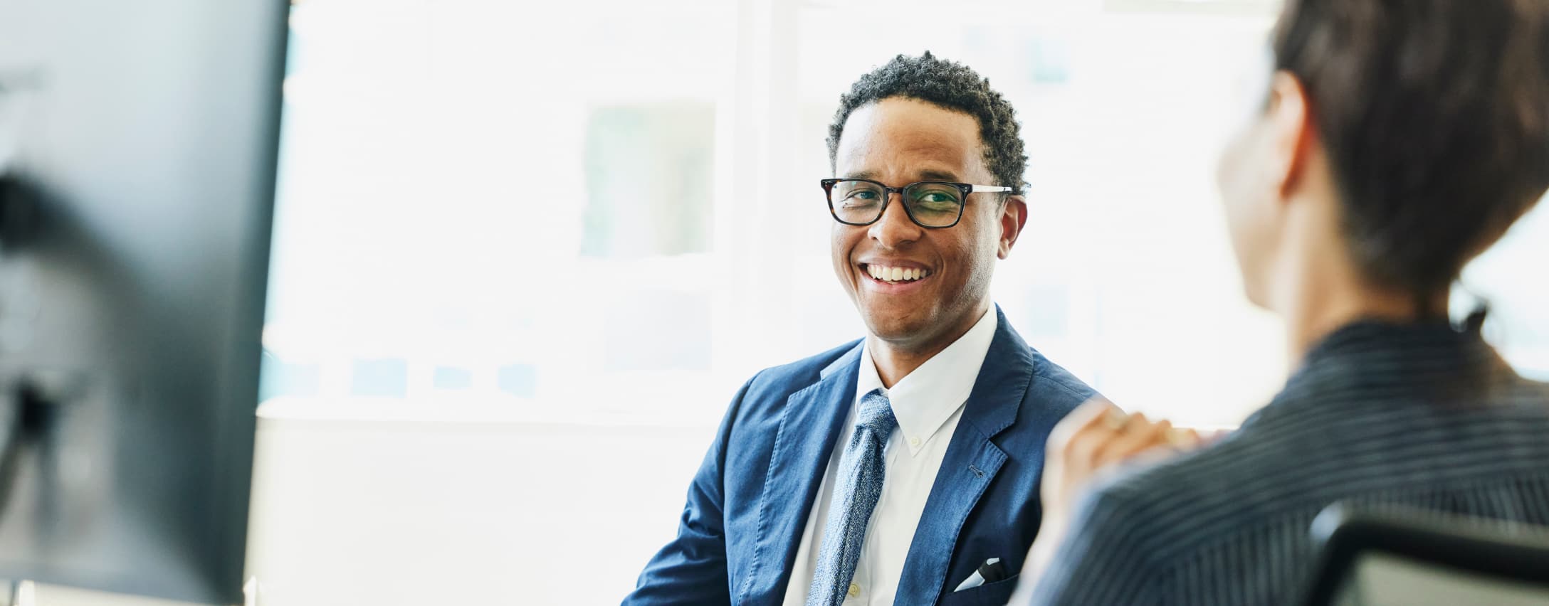 Man smiling in a conference room