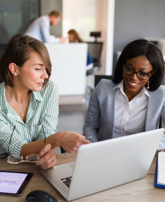 Two women working on a laptop