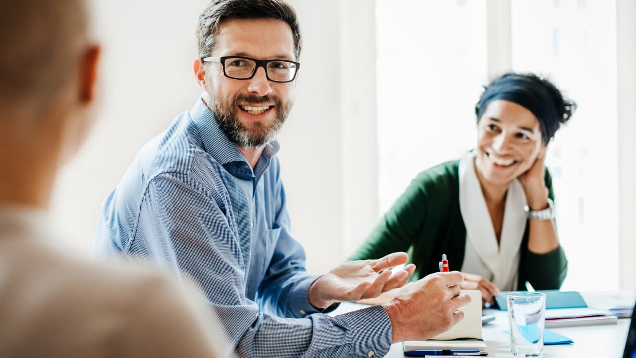 Man smiling in conference room