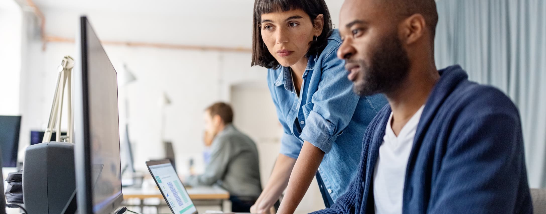 Man and woman looking at a monitor
