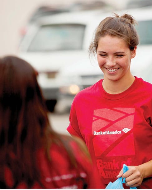 Smiling employee in red Bank of America t-shirt