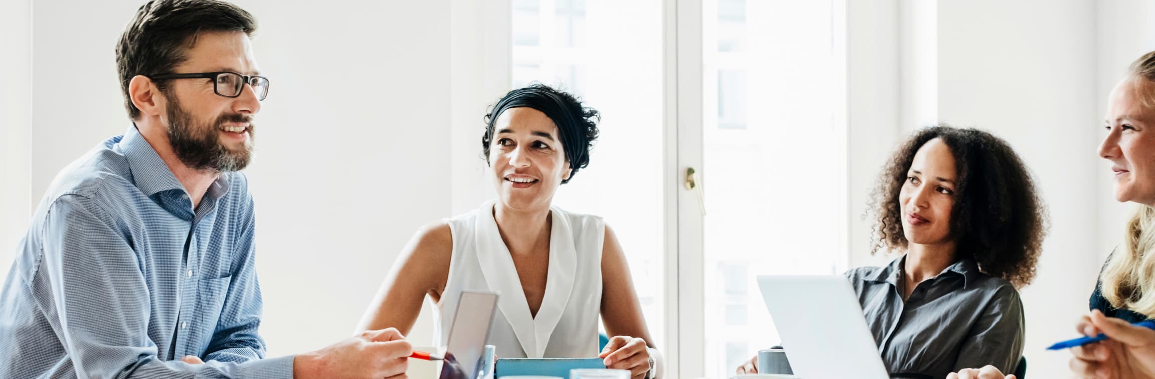 Three co-workers sitting at table