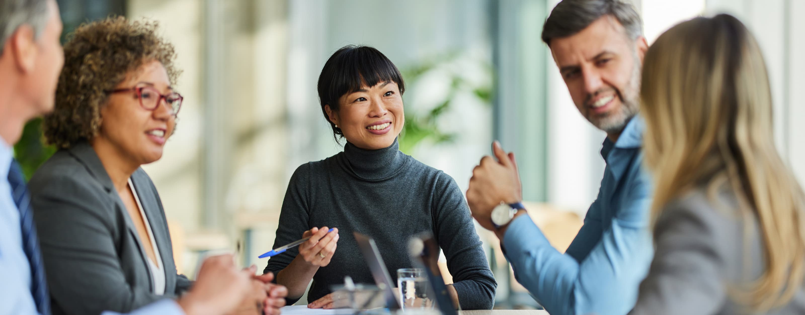 Diverse group of adults talking at a table
