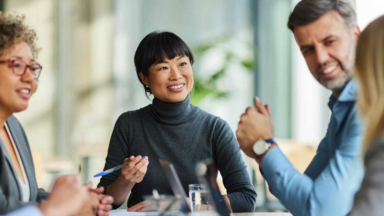 Diverse group of adults talking at a table