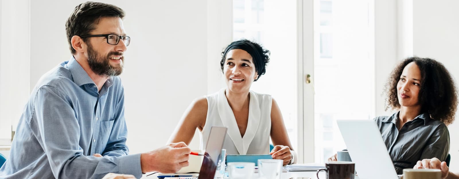 Three co-workers sitting at table