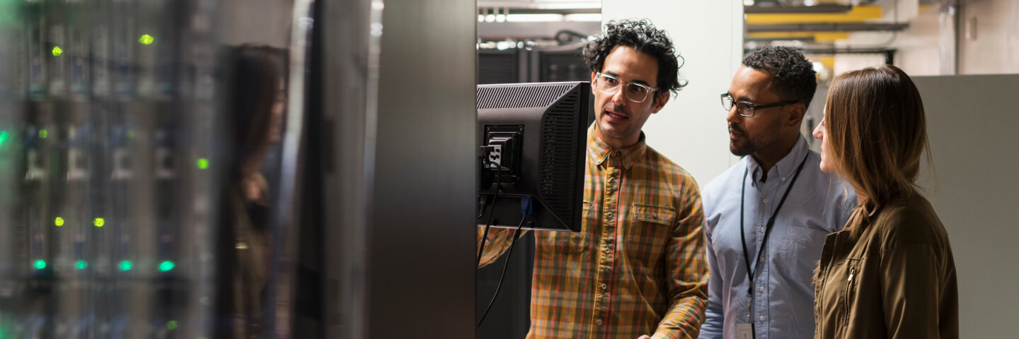 A technician showing students material in a server room