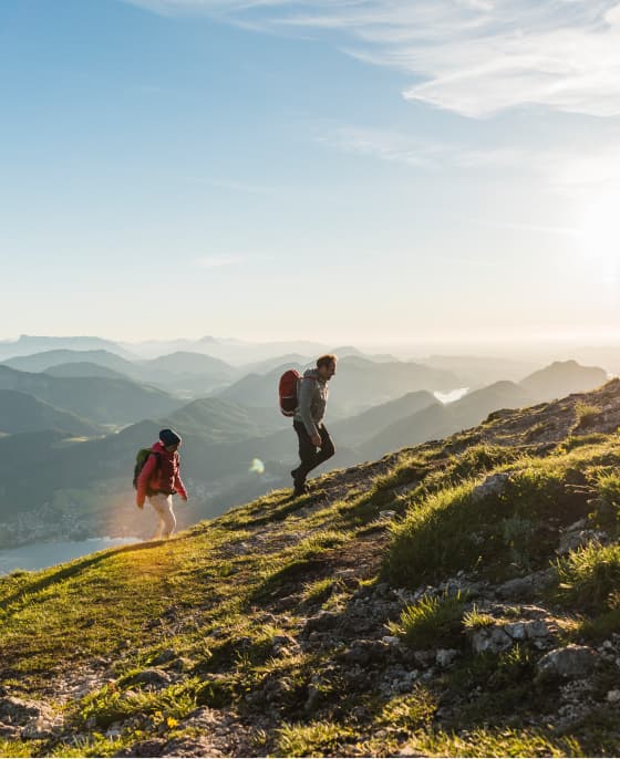 Two hikers moving up a mountain