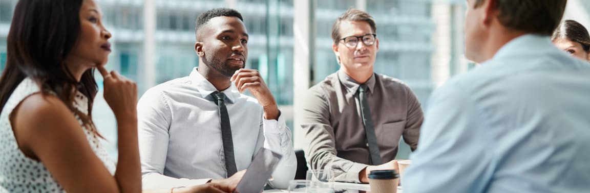 Group of coworkers sitting around a table for a meeting