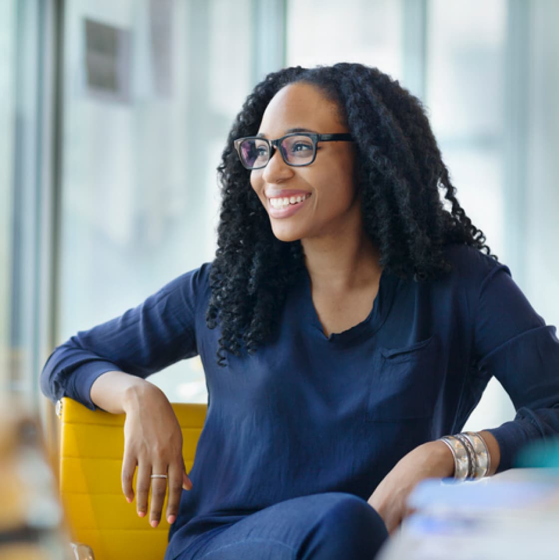 Smiling, confident woman employee in a meeting room