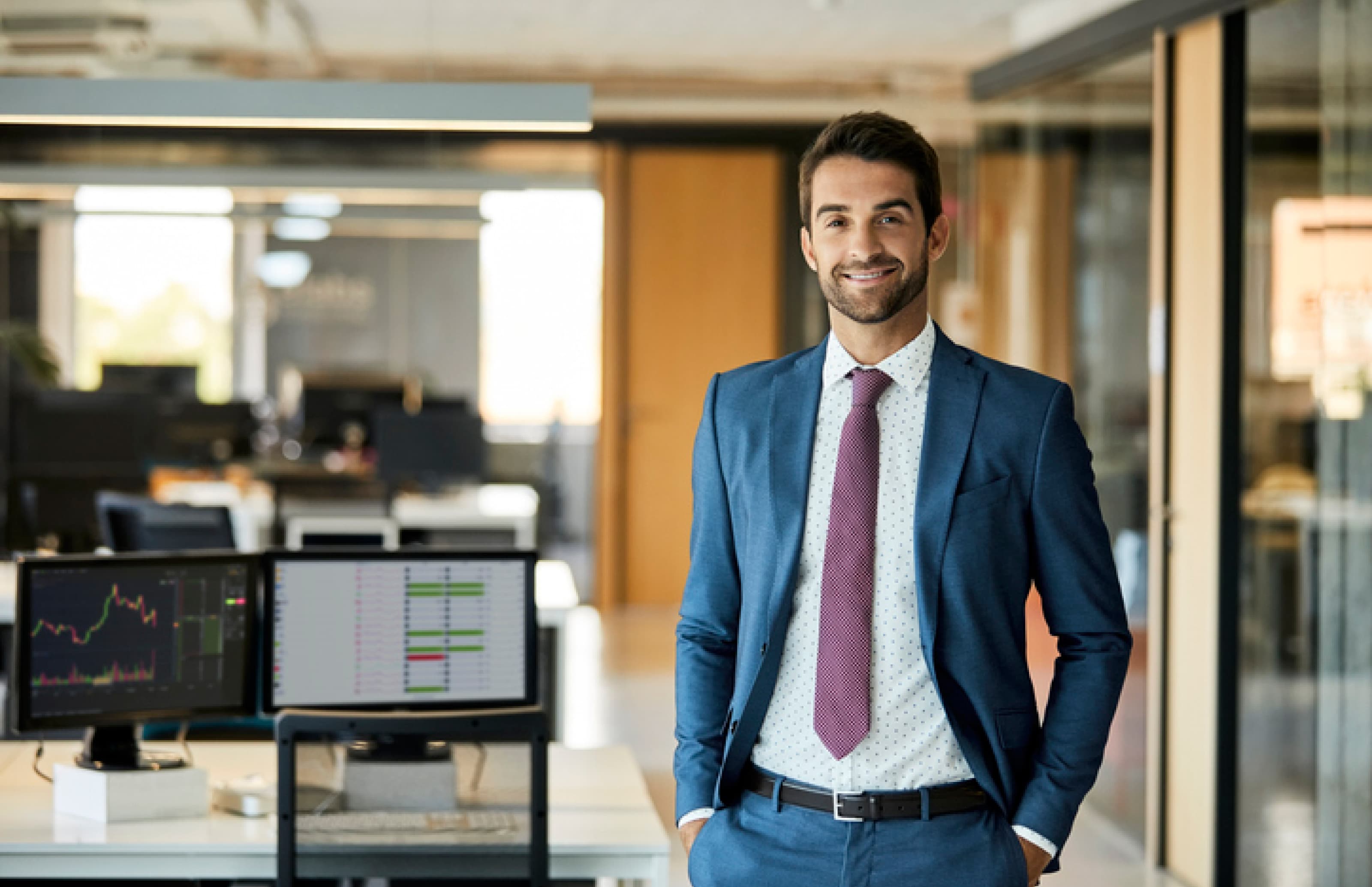 Smiling, confident bank employee dressed in a suit and tie