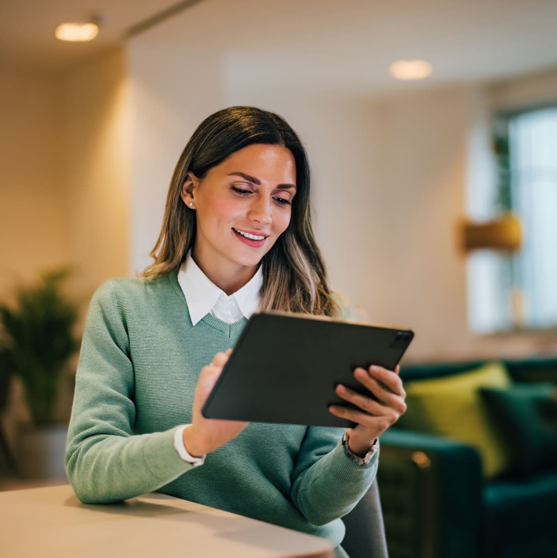 Smiling woman employee working on a tablet