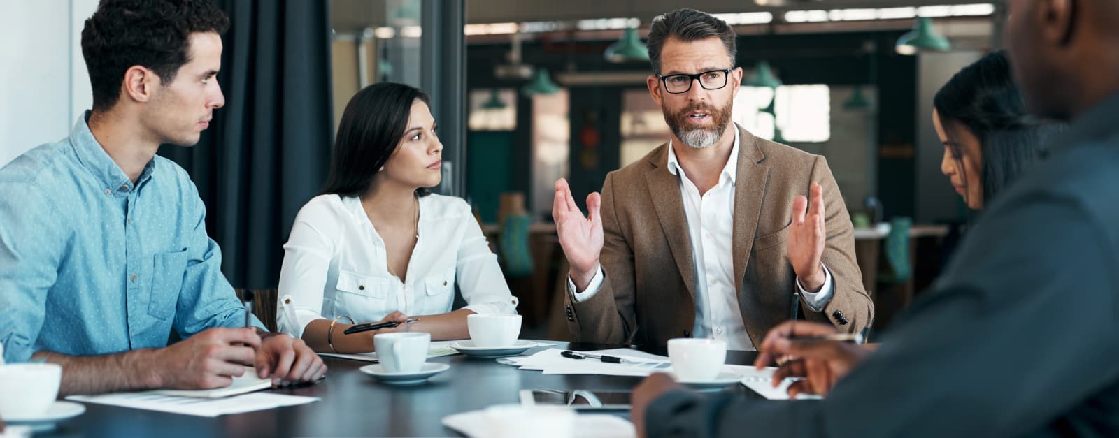 A man speaking with his colleagues