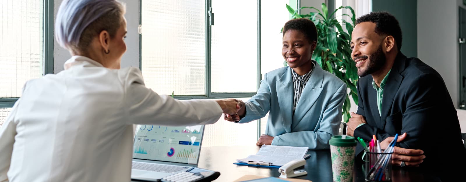Man and woman meeting with a woman banker