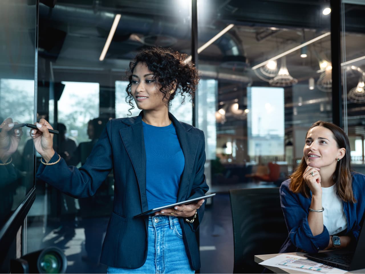 Woman presenting on a screen to others