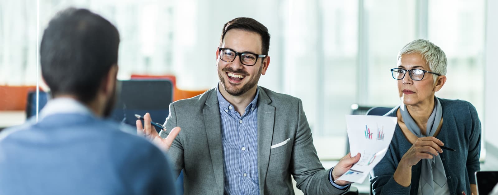 A man smiling during a business meeting